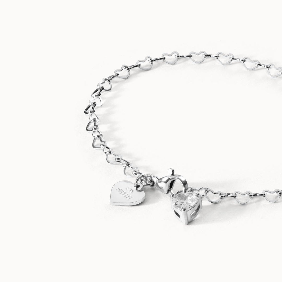 Ultra Close-up of PURELEI Endless Love Bracelet with heart-shaped silver chain links and sparkling zirconia heart pendant, elegant and timeless.