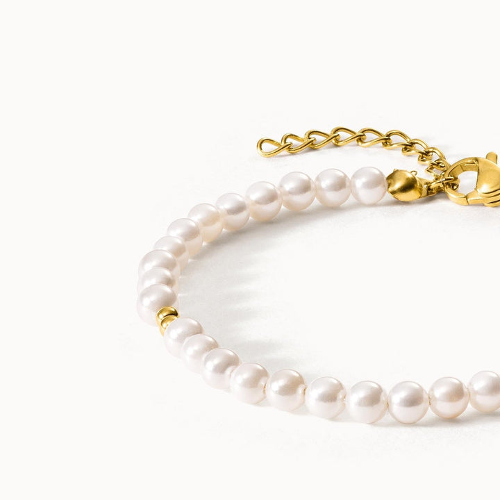 Ultra Close-up of an elegant 18K gold-plated Finesse Bracelet by PURELEI featuring small freshwater pearl embellishments and adjustable links.