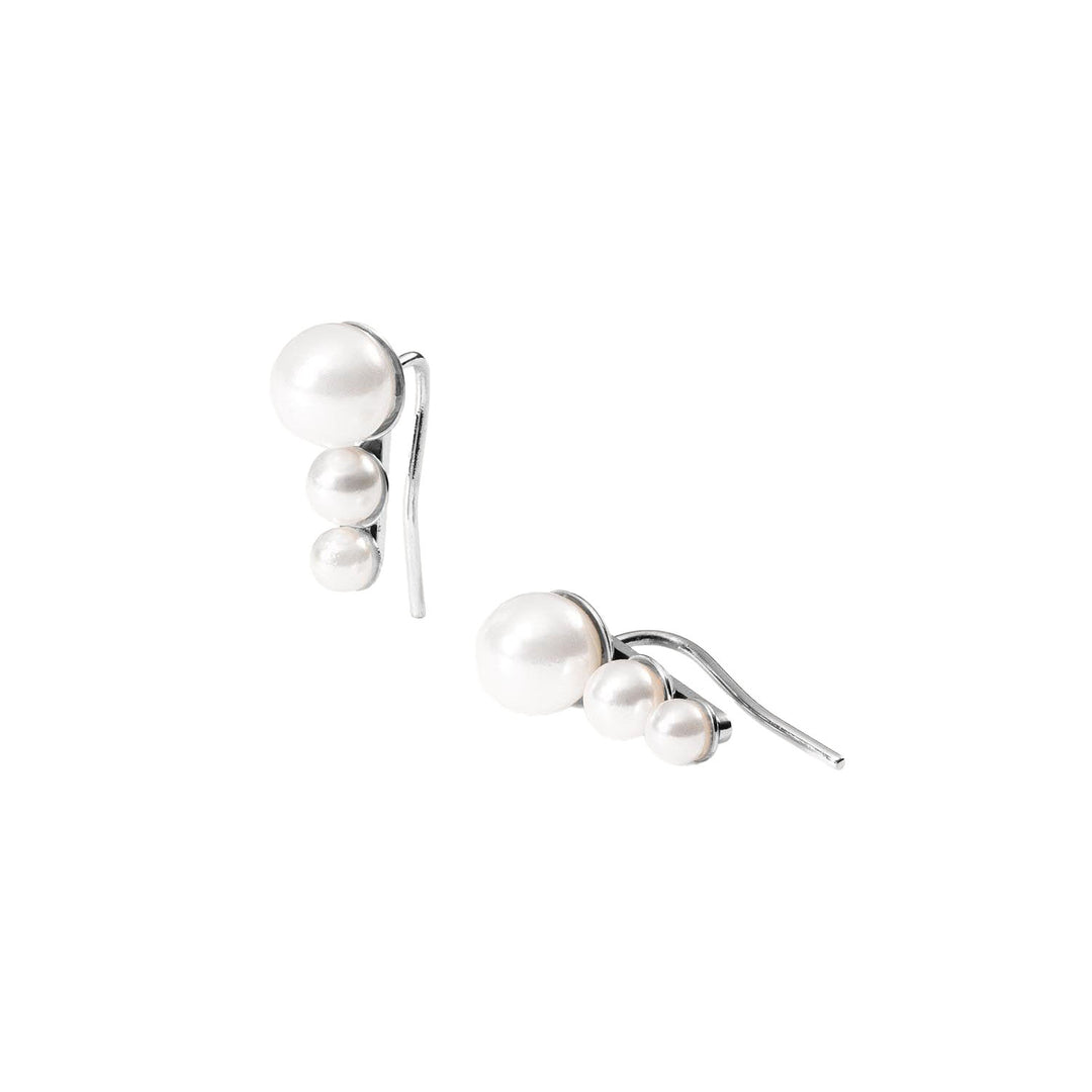 Close-up of PURELEI Finesse Earrings in Silver with elegant Sea Shell Pearls in a modern ear crawler 