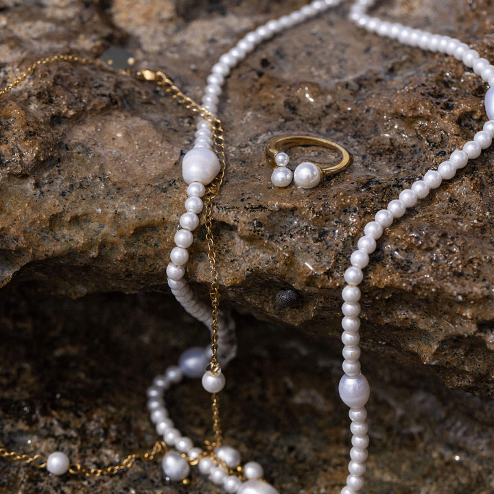 Close-up of the PURELEI Finesse Ring in gold with matching Finesse necklace, bracelet, and earrings.