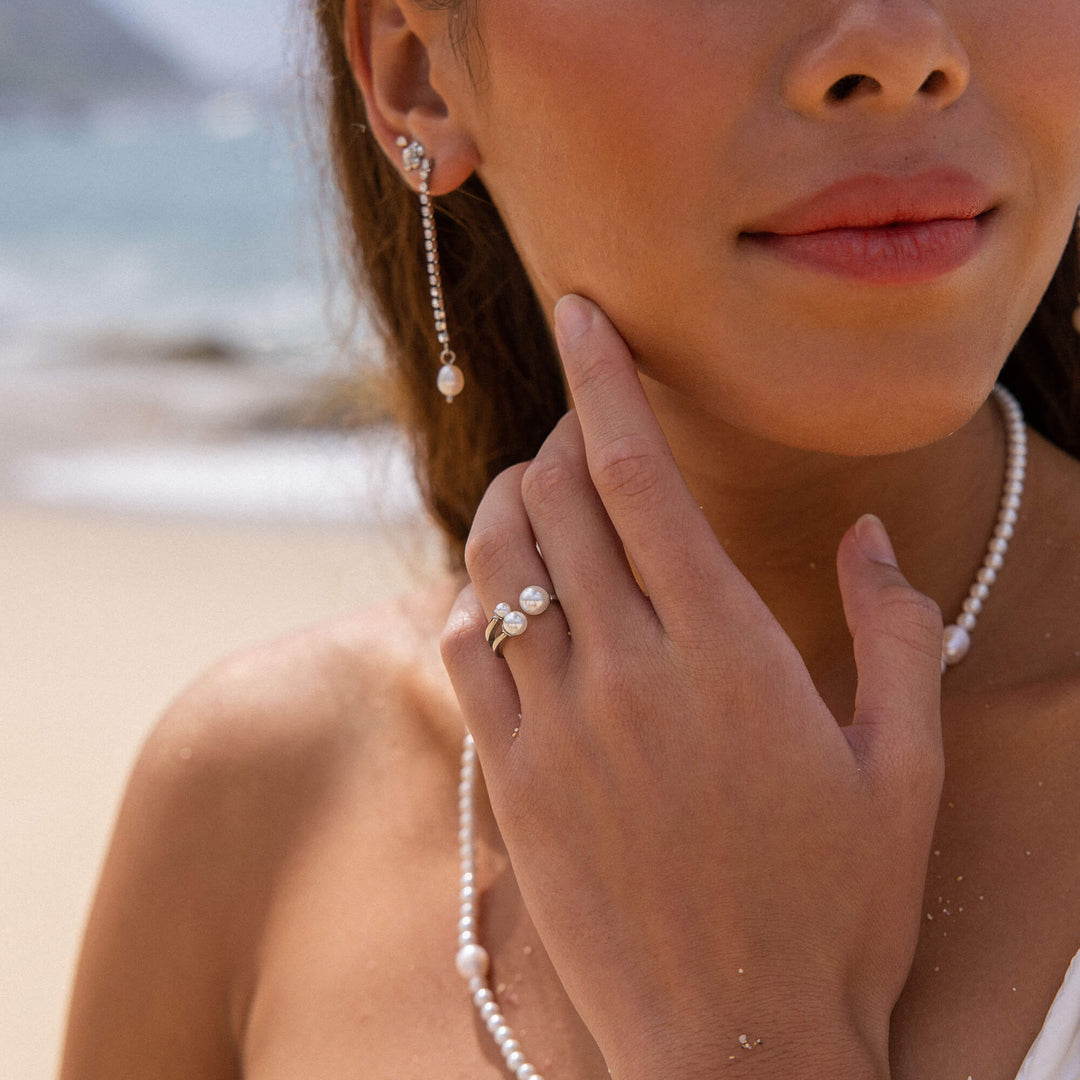 Woman wearing the PURELEI Finesse Ring in silver on her left hand, styled with matching Finesse necklace, bracelet, and earrings.