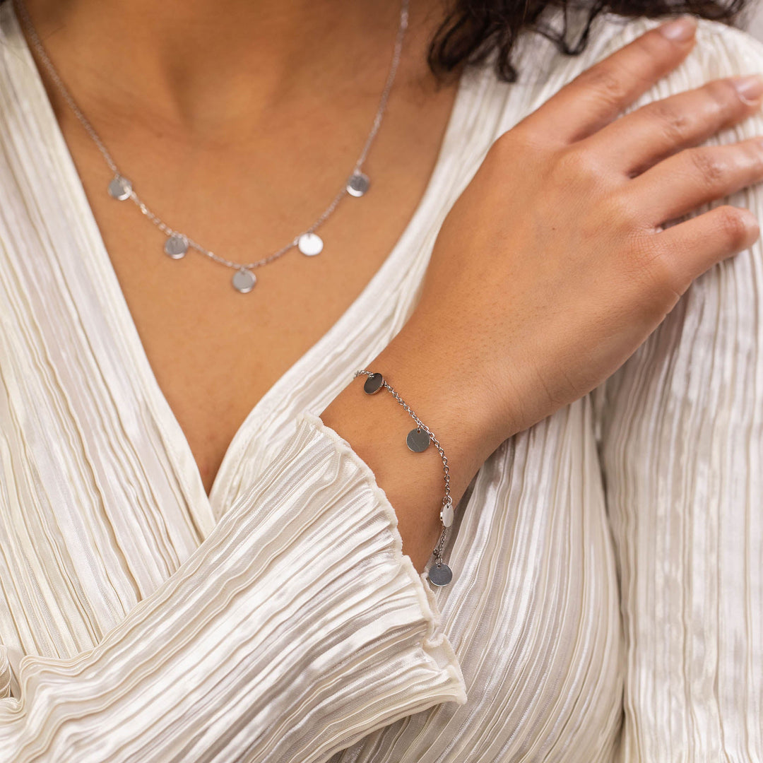 Woman wearing the Silver Kalea Necklace on her neck, paired with the PURELEI Silver Kalea Bracelet on her left arm for a coordinated, elegant look.