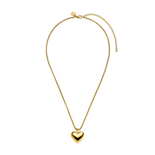 Ultra Close-up of PURELEI Lovebird Necklace in gold with a shiny heart pendant, adjustable chain, and elegant romantic design.