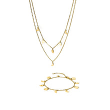Close-up of the PURELEI Luna Set in gold, featuring a moon phase necklace and matching bracelet with delicate moon-shaped charms.