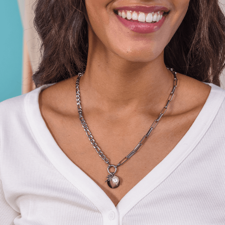 Woman wearing PURELEI Palmtree Charm on a matching Silver necklace, showcasing its elegant and personalized design.